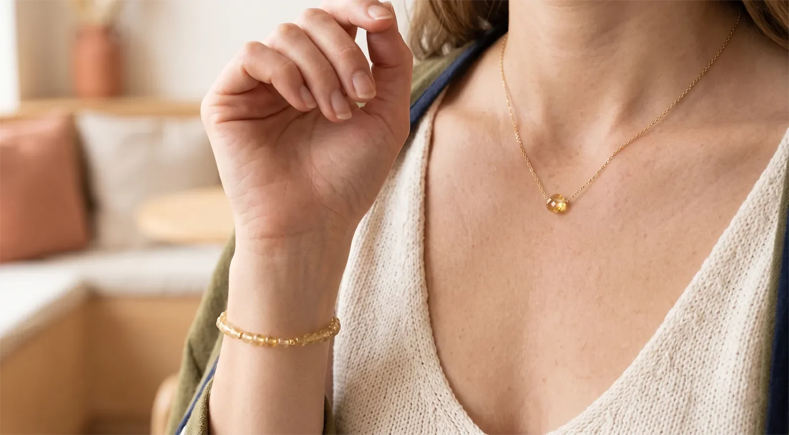 Woman wearing citrine bracelet and necklace with a soft neutral outfit