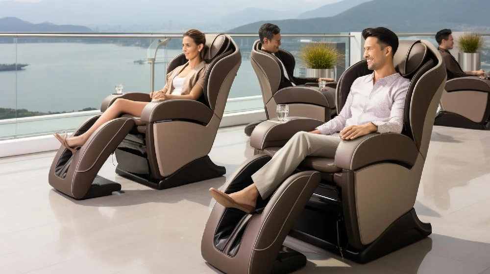 Ba người đang thư giãn trên ghế massage đặt trên bãi biển, hướng ra đại dương dưới bầu trời trong xanh. Hình ảnh kết hợp giữa chăm sóc sức khỏe và thư giãn trong khung cảnh biển nhiệt đới