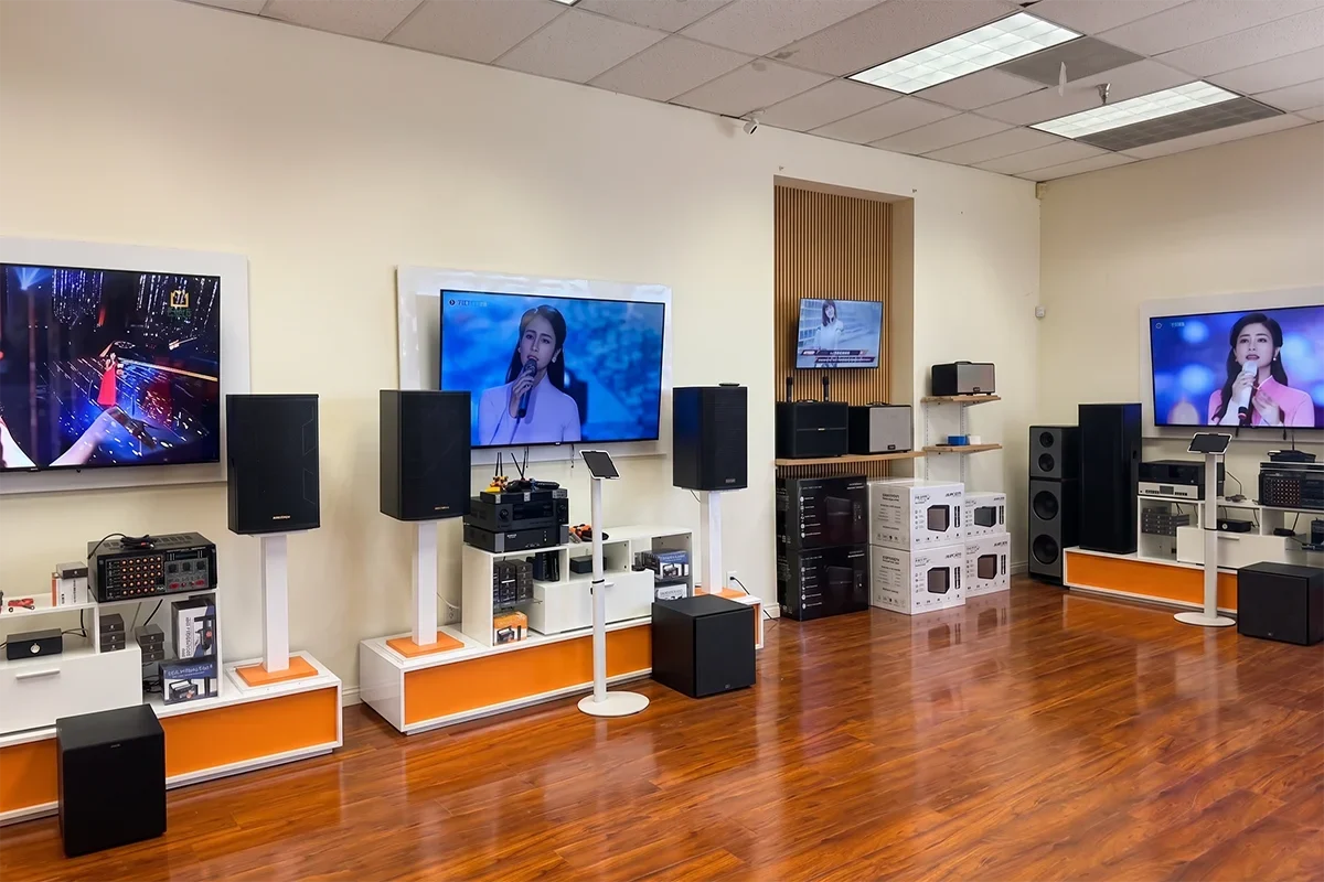 Tittac karaoke showroom area with speakers, amplifiers, and TV displays for in-person comparison